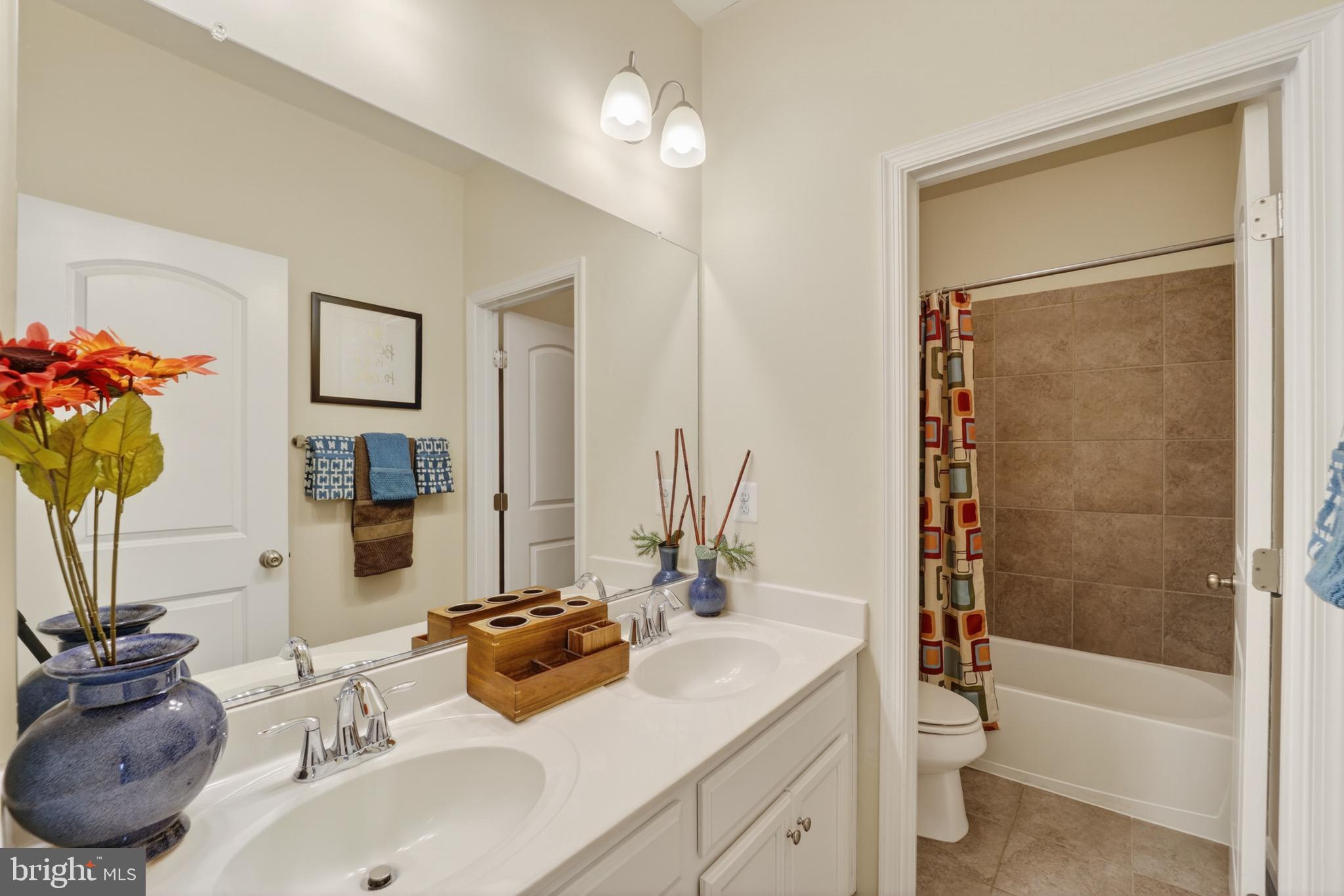 9205 Rice Avenue Lanham, MD 20706 - Photo 34 of 68 a bathroom with a tub sink toilet and a mirror