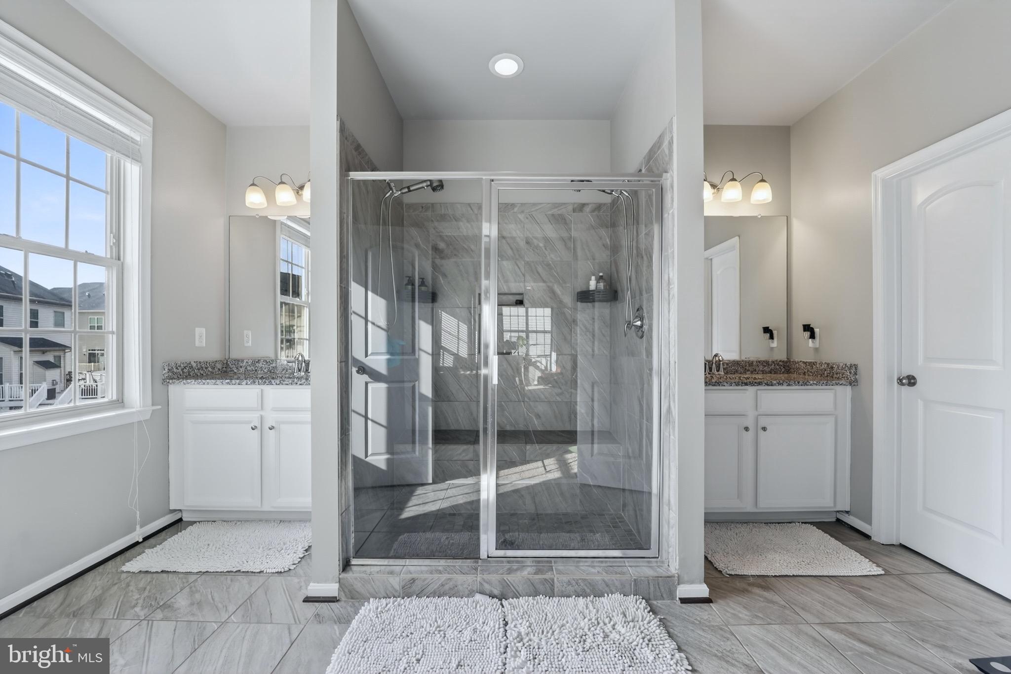 9205 Rice Avenue Lanham, MD 20706 - Photo 40 of 68 a bathroom with a shower sink and mirror