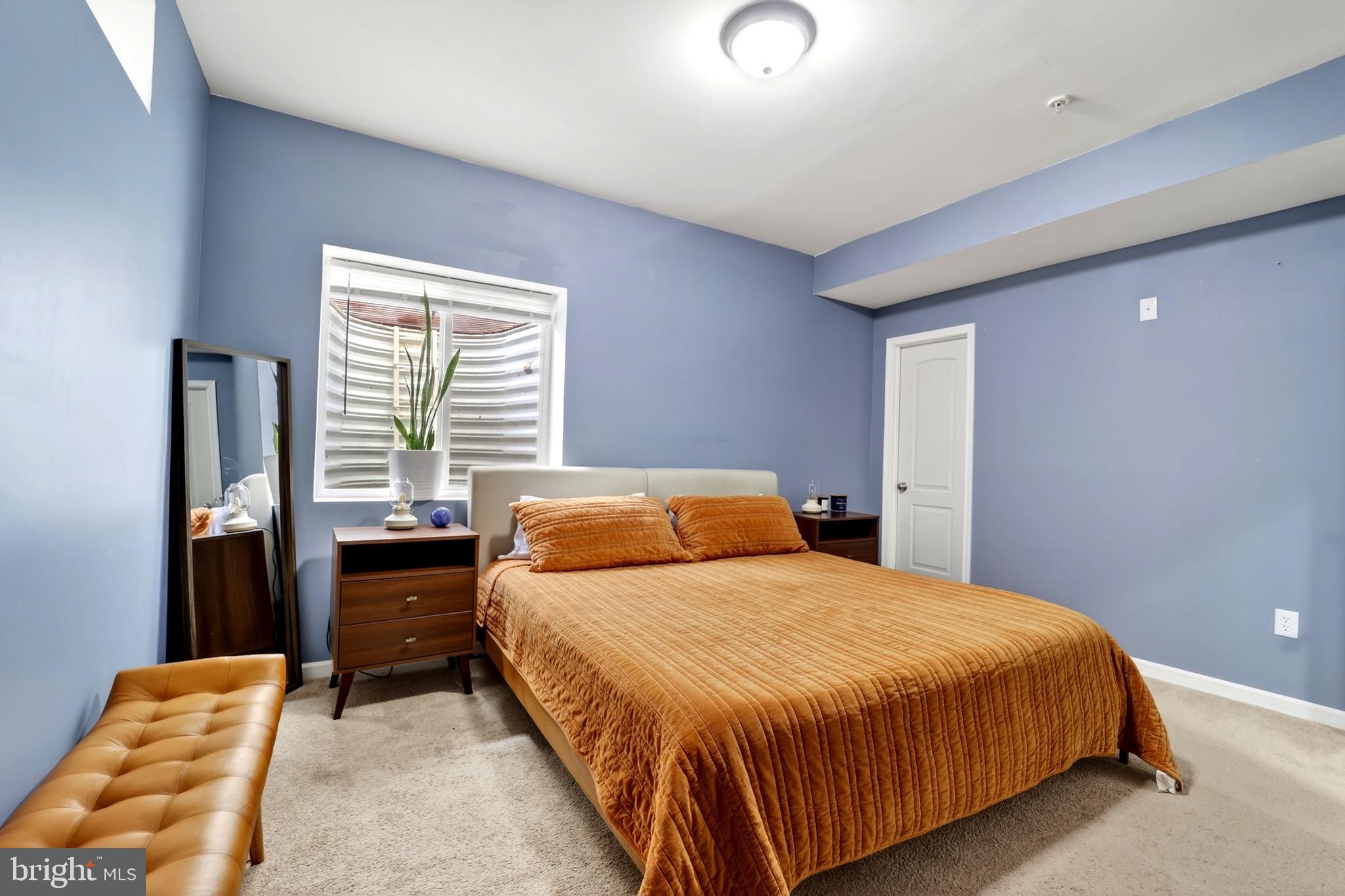 9205 Rice Avenue Lanham, MD 20706 - Photo 46 of 68 a bedroom with a bed and wooden floor