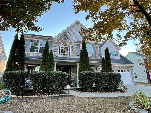 a front view of a house with a yard