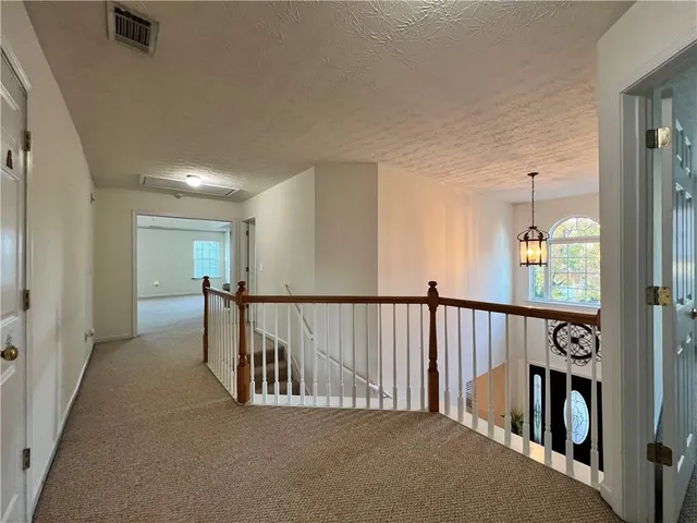 a view of a hallway with seating area
