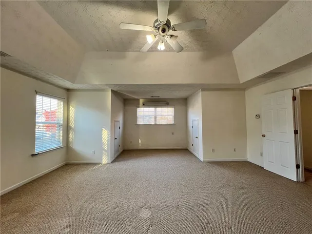 a view of a livingroom with a ceiling fan and window
