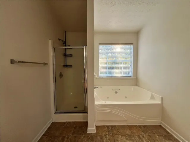 a bathroom with a bathtub and shower