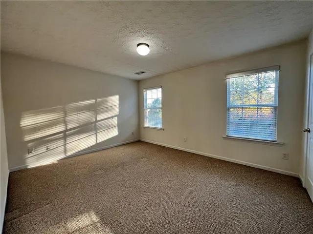 an empty room with a empty space and a window