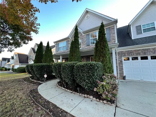 a front view of a house with a yard