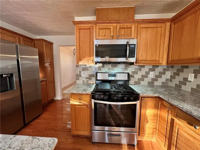 a kitchen with a stove and a microwave