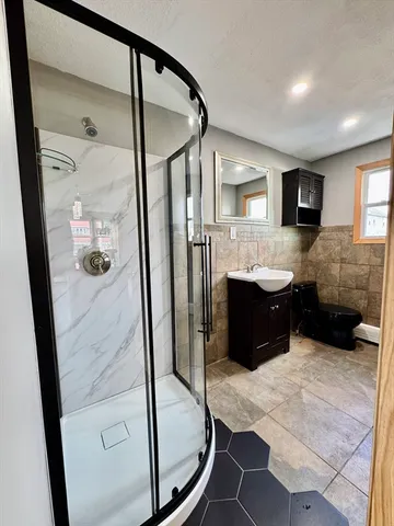 a bathroom with a tub mirror and window