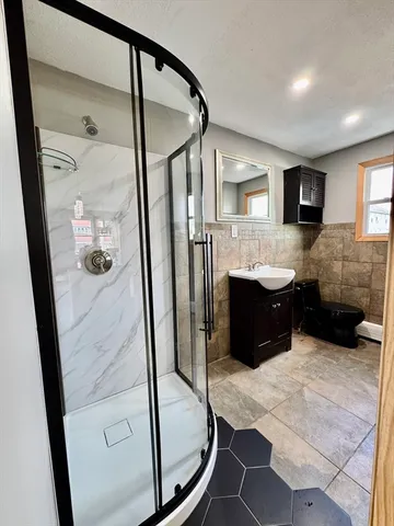 a bathroom with a tub mirror and window