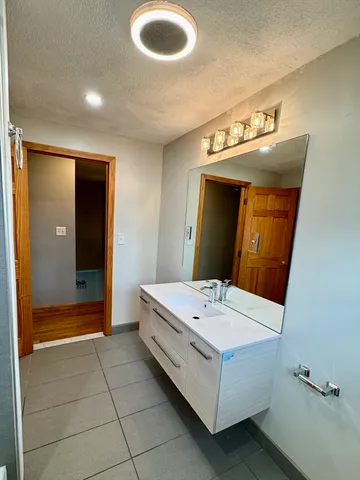 a bathroom with a double vanity sink and a mirror