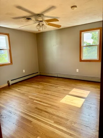 a view of a room with wooden floor and a window