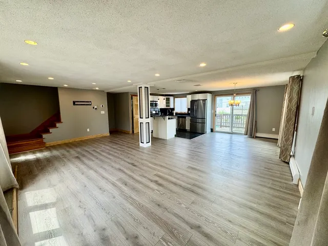 a view of a kitchen with a sink and a refrigerator