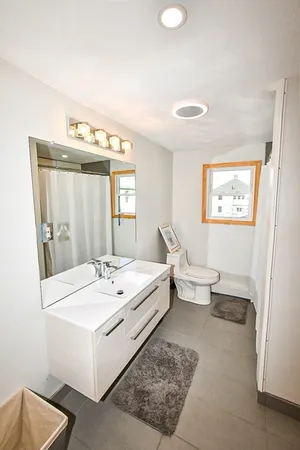 a spacious bathroom with a double vanity sink and a mirror