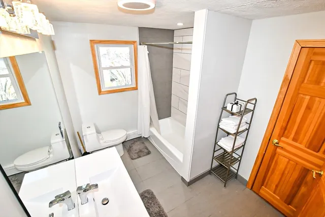 a living room with furniture and a baby crib