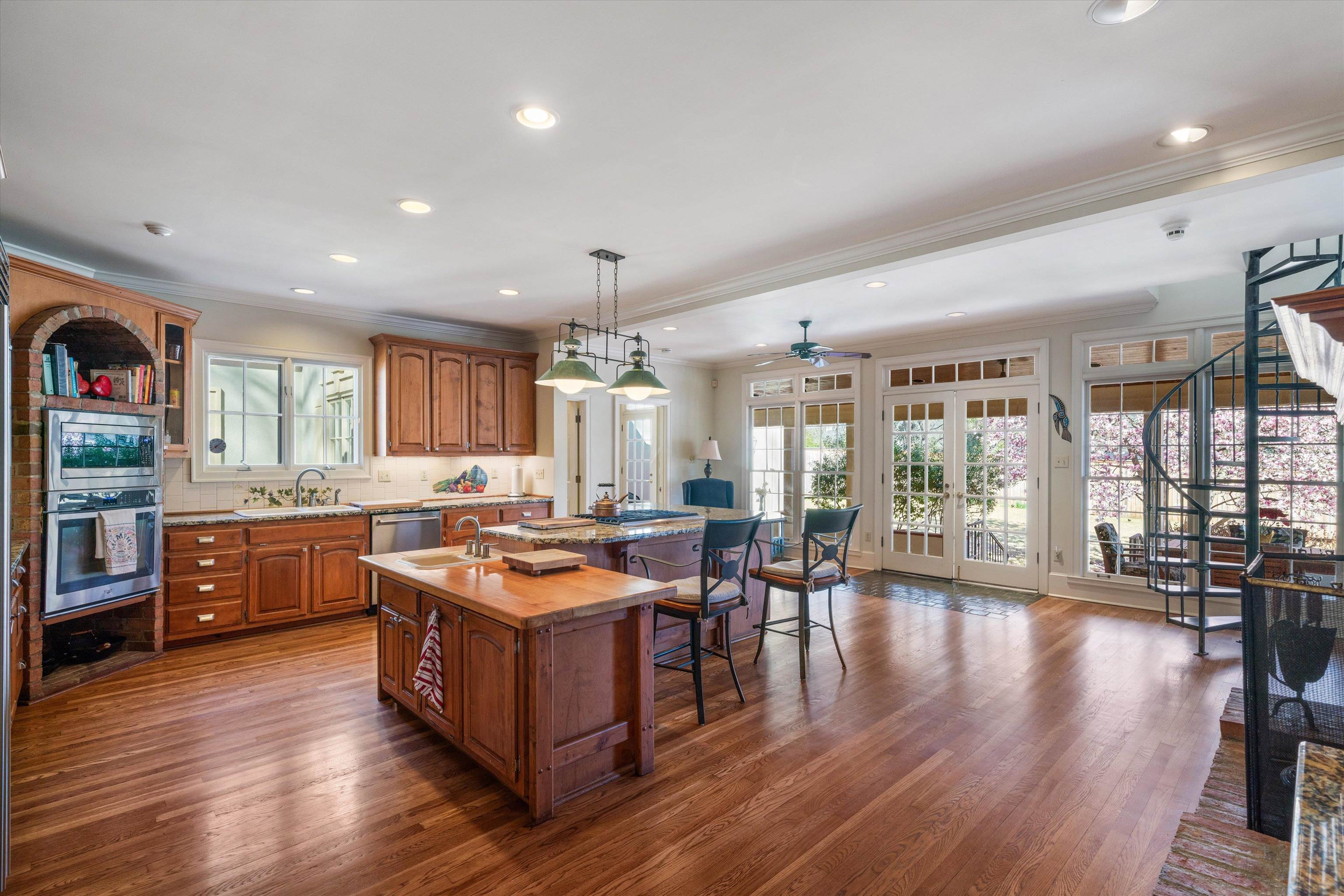 352 Colonial Road Memphis, TN 38117 - Photo 7 of 31 a kitchen with stainless steel appliances granite countertop wooden floors and view
