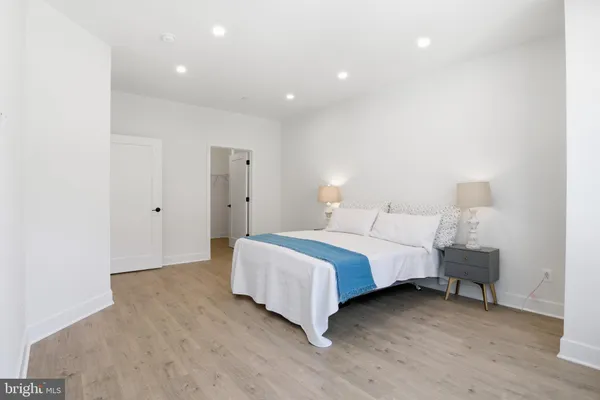 a spacious bedroom with a bed and a table
