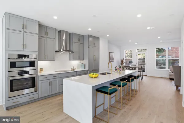 a kitchen with stainless steel appliances granite countertop a stove and a sink