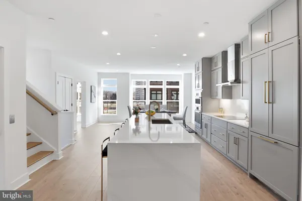 a kitchen with stainless steel appliances refrigerator oven and cabinets
