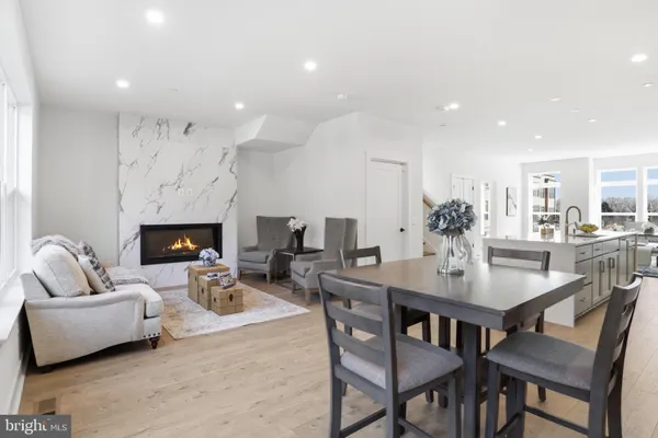 a living room with furniture kitchen view and a fireplace
