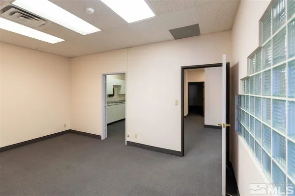 an empty room with closet and bathroom