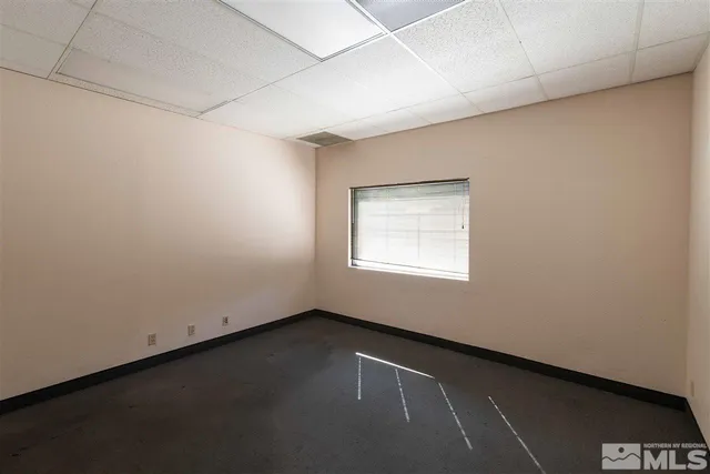 an empty room with a empty space and a window
