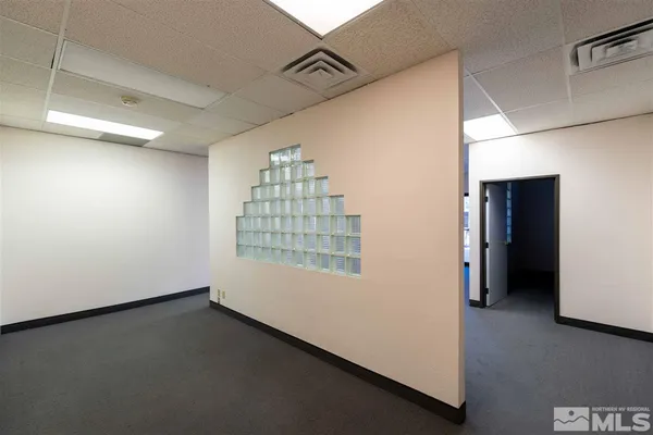 a view of an empty room and a window