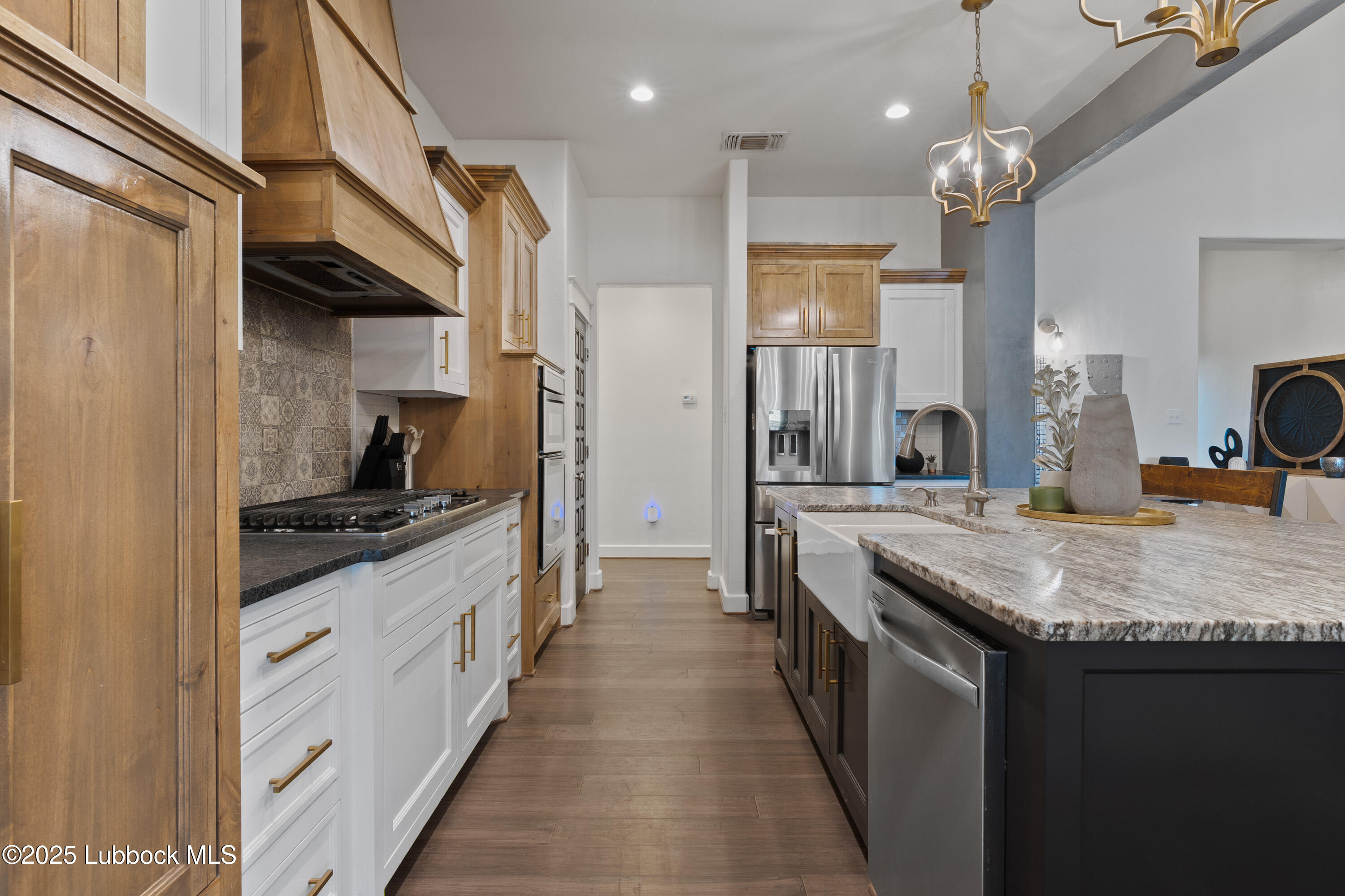 5125 County Road 7930 Lubbock, TX 79424 - Photo 14 of 75 a kitchen with stainless steel appliances granite countertop a sink stove and refrigerator