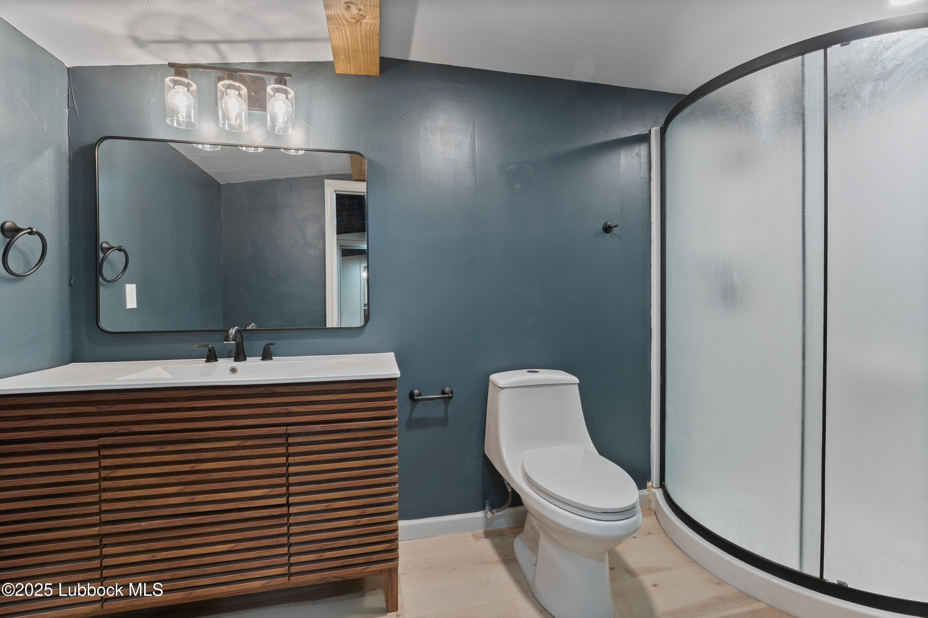 5125 County Road 7930 Lubbock, TX 79424 - Photo 57 of 75 a bathroom with a sink a toilet and mirror