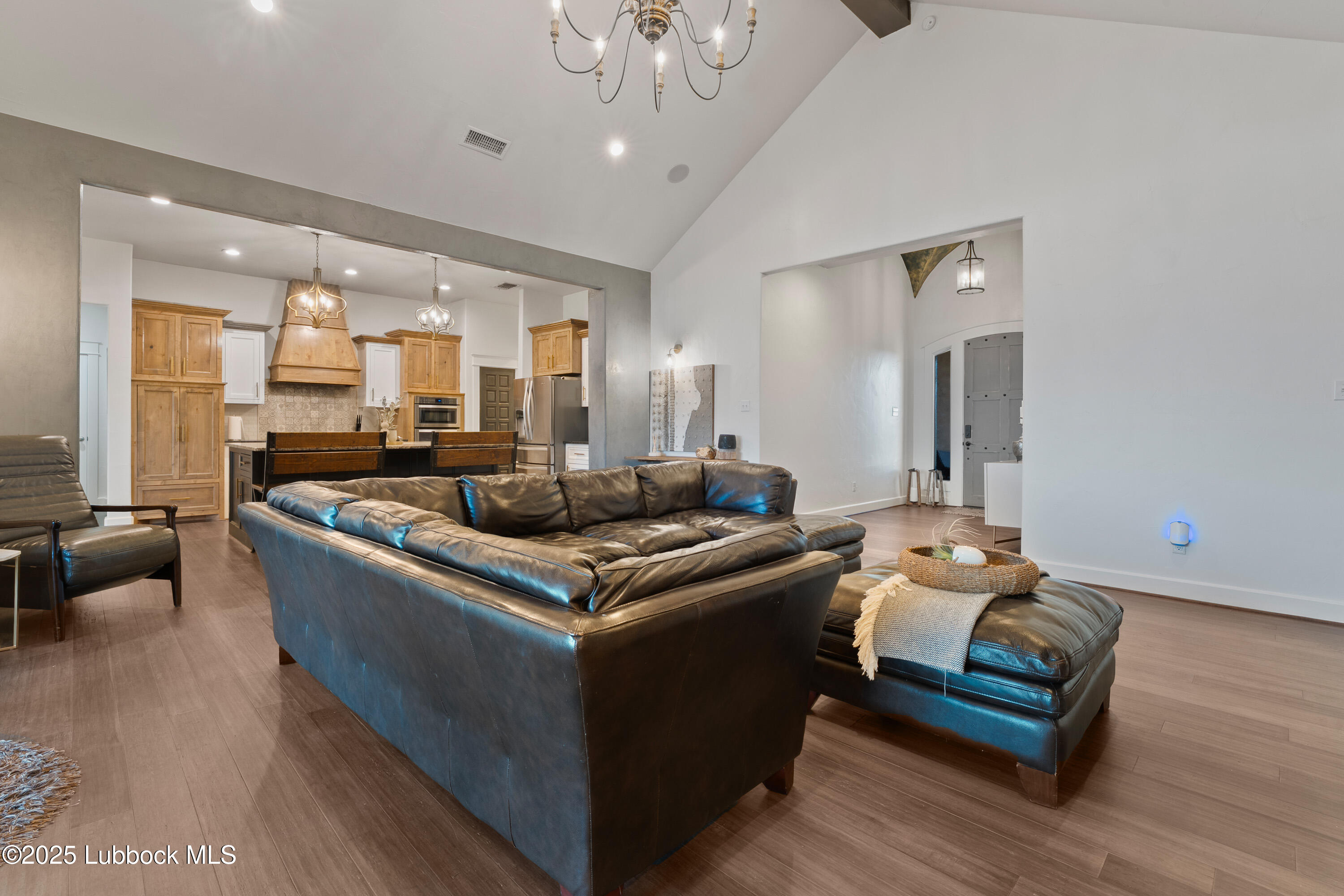 5125 County Road 7930 Lubbock, TX 79424 - Photo 10 of 75 a living room with furniture and a chandelier
