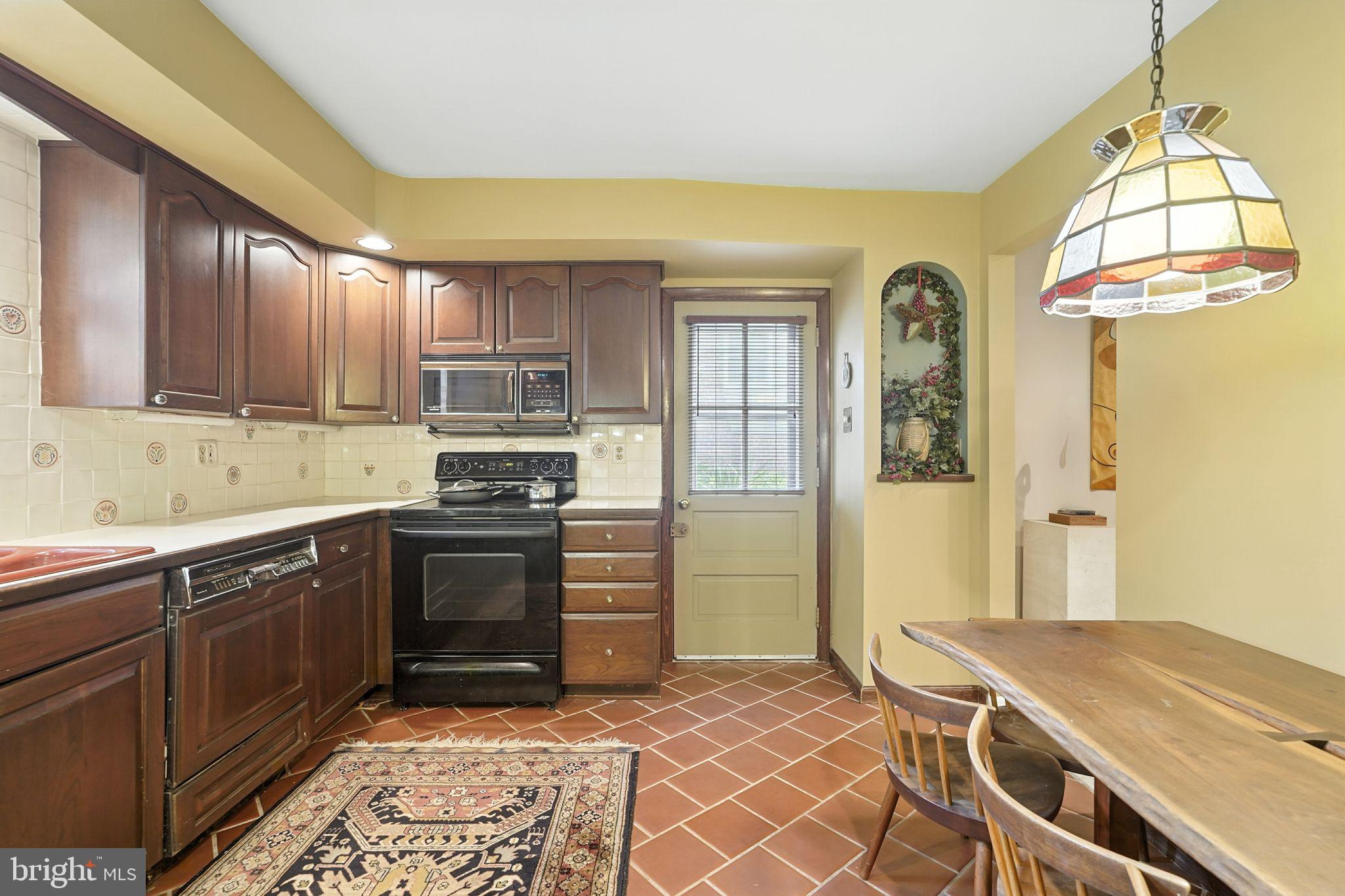 8420 Chippewa Road Philadelphia, PA 19128 - Photo 6 of 30 a kitchen with a stove a sink and a refrigerator