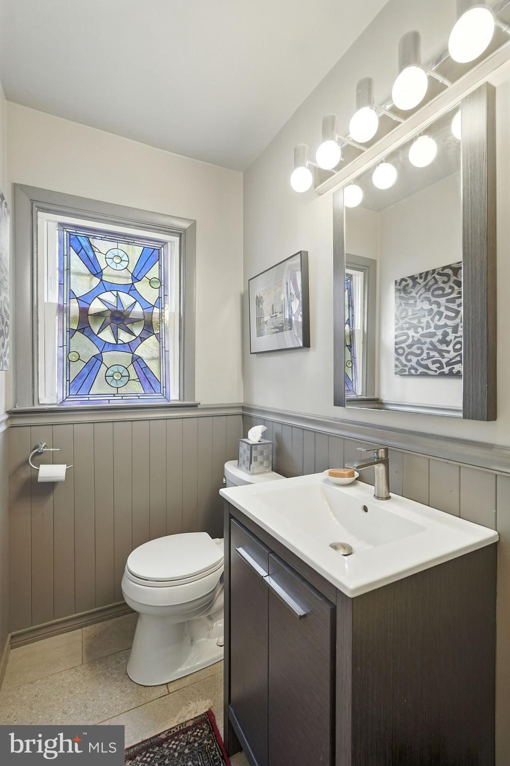 8420 Chippewa Road Philadelphia, PA 19128 - Photo 8 of 30 a bathroom with a sink a toilet a mirror and vanity