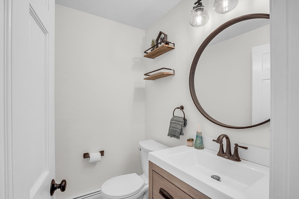 71B South Road Pepperell, MA 01463 - Photo 12 of 42 a bathroom with a sink a toilet and a mirror