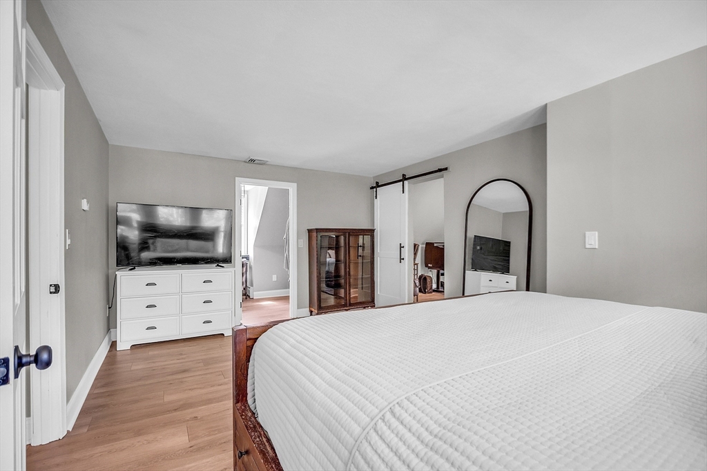 71B South Road Pepperell, MA 01463 - Photo 24 of 42 a bedroom with a bed and a flat screen tv
