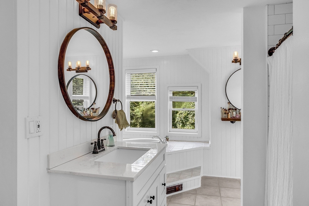 71B South Road Pepperell, MA 01463 - Photo 26 of 42 a bathroom with a sink a mirror and a window