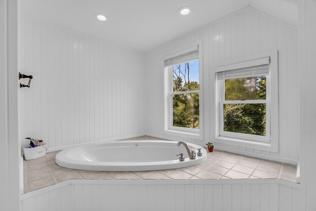 71B South Road Pepperell, MA 01463 - Photo 27 of 42 a bathroom with a granite countertop bathtub and window