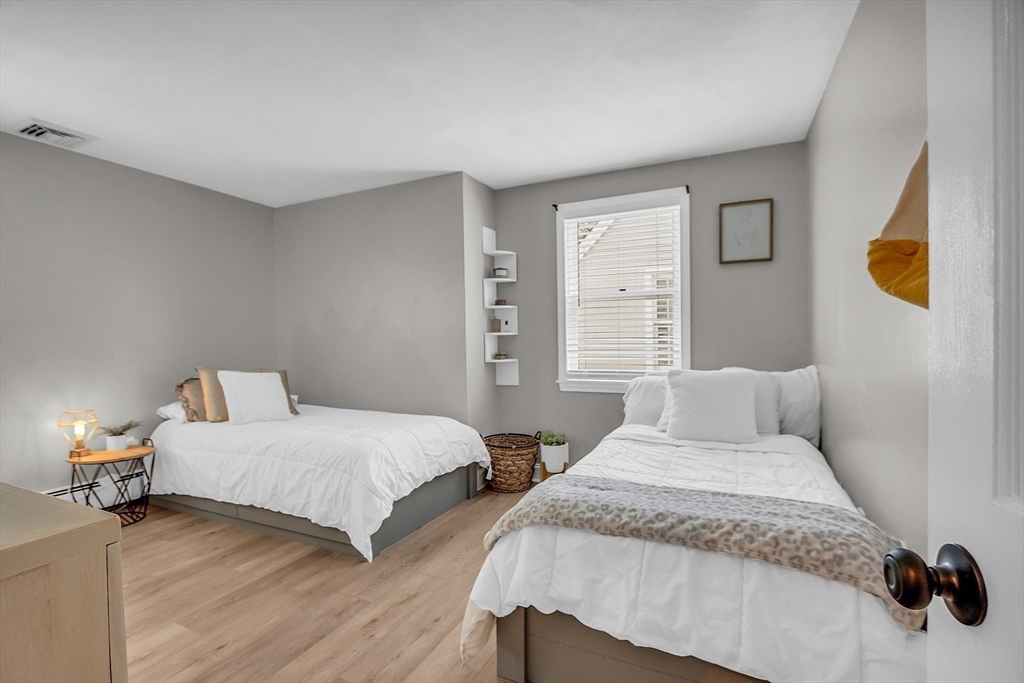 71B South Road Pepperell, MA 01463 - Photo 31 of 42 a bedroom with two beds and painting on the wall