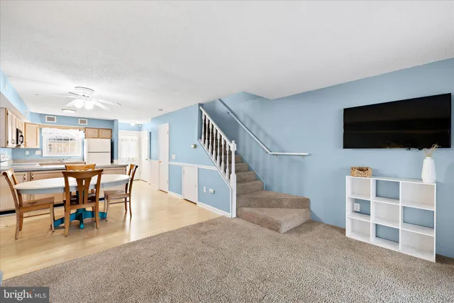 a view of a livingroom with furniture and staircase