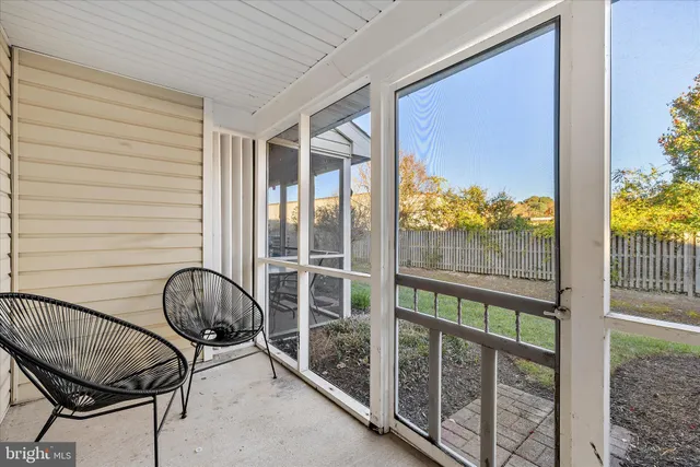 a view of a room with wooden floor and windows