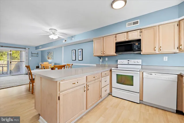 a kitchen with white cabinets and sink