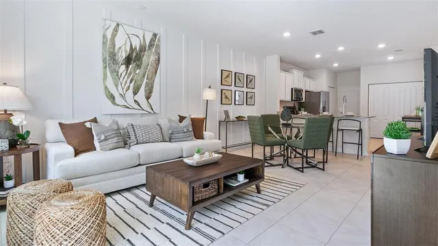 a living room with furniture a rug and a painting