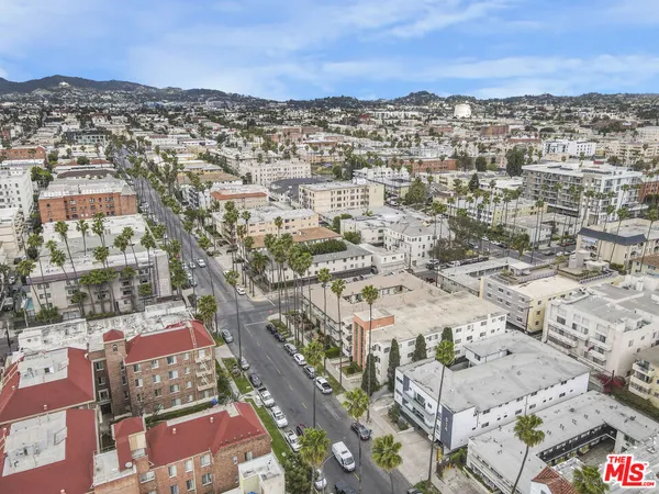 an aerial view of residential houses with city view