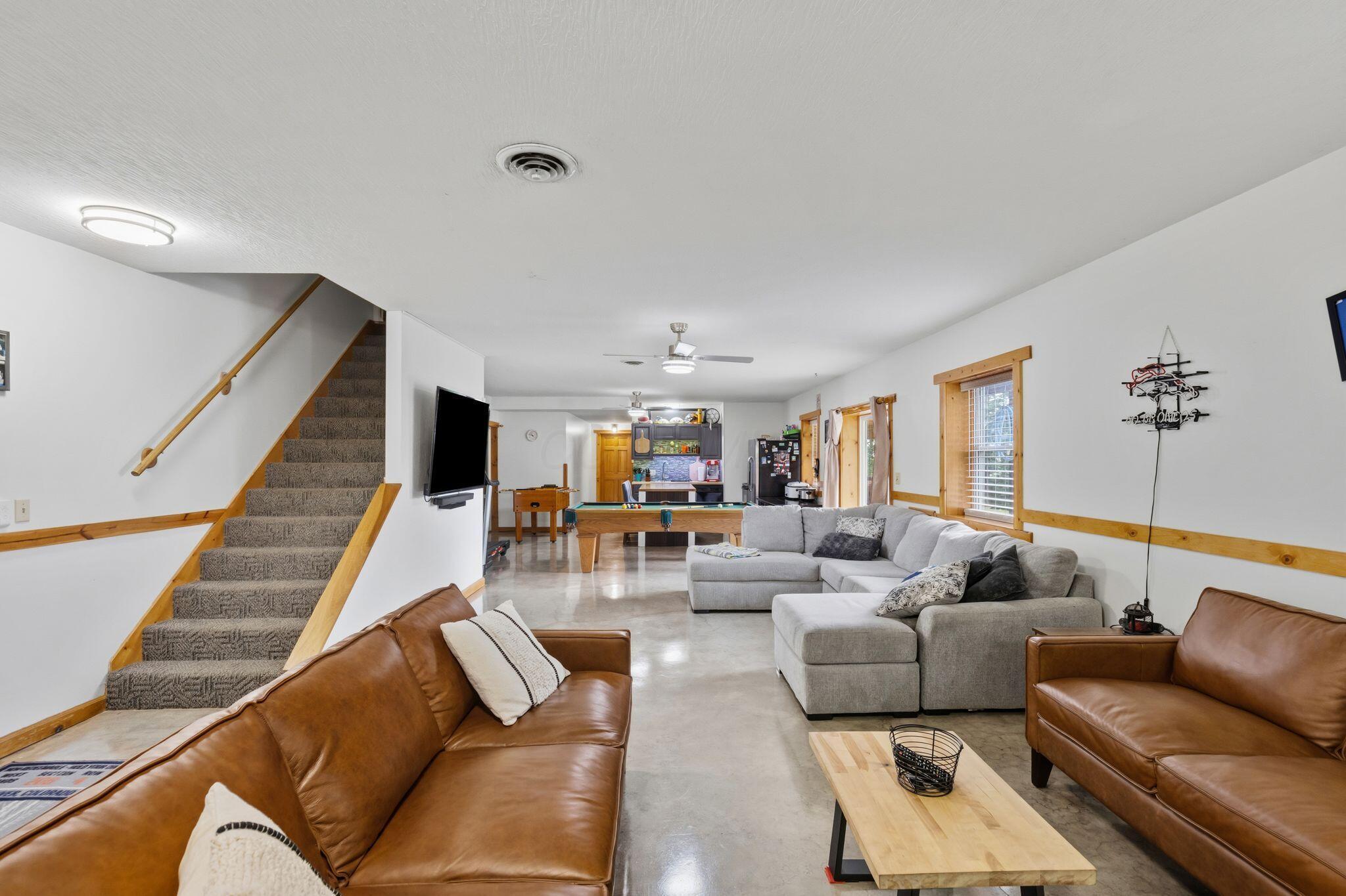 10446 Rich Hollow Road Southwest Lancaster, OH 43130 - Photo 6 of 83 Spacious lower-level living area featuring concrete flooring and a neutral color palette
