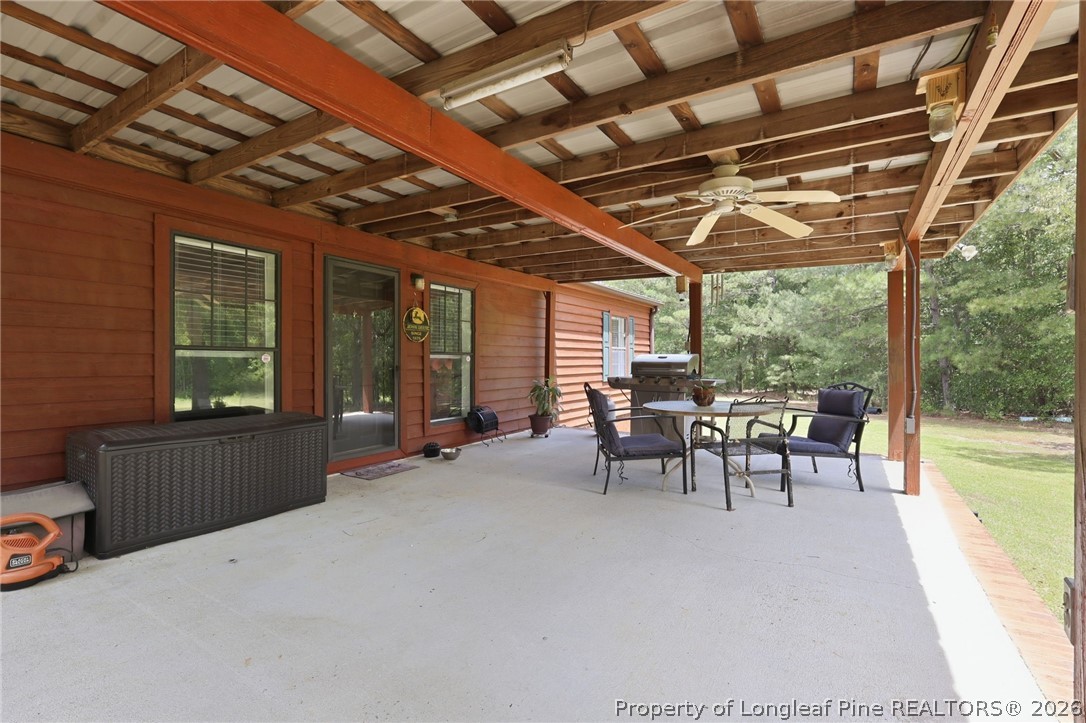 10400 Ruth Vinson Road Autryville, NC 28318 - Photo 20 of 49 a view of a porch with furniture and a yard
