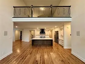a view of a living room with wooden floor and a bathroom