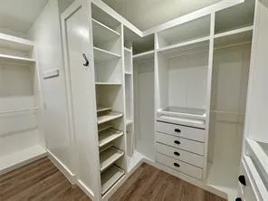 a view of walk in closet with empty racks