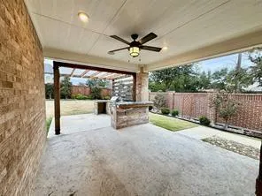 a view of a porch with furniture and a backyard