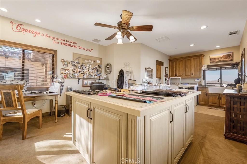 61138 Onaga Trail Joshua Tree, CA 92252 - Photo 11 of 20 a kitchen with stainless steel appliances kitchen island granite countertop a sink and cabinets