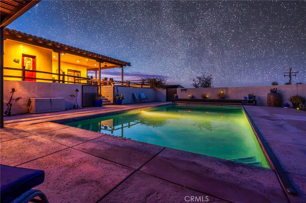 61138 Onaga Trail Joshua Tree, CA 92252 - Photo 6 of 20 a swimming pool with lawn chairs