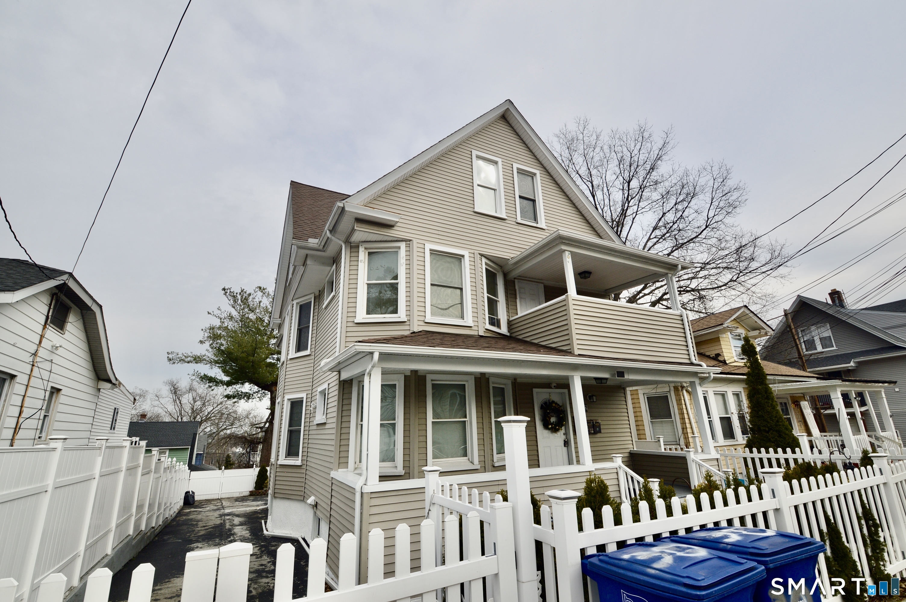 32 Boston Terrace Bridgeport, CT 06610 - Photo 1 of 14 a front view of a house with a yard