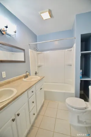 a bathroom with a sink a toilet and bathtub