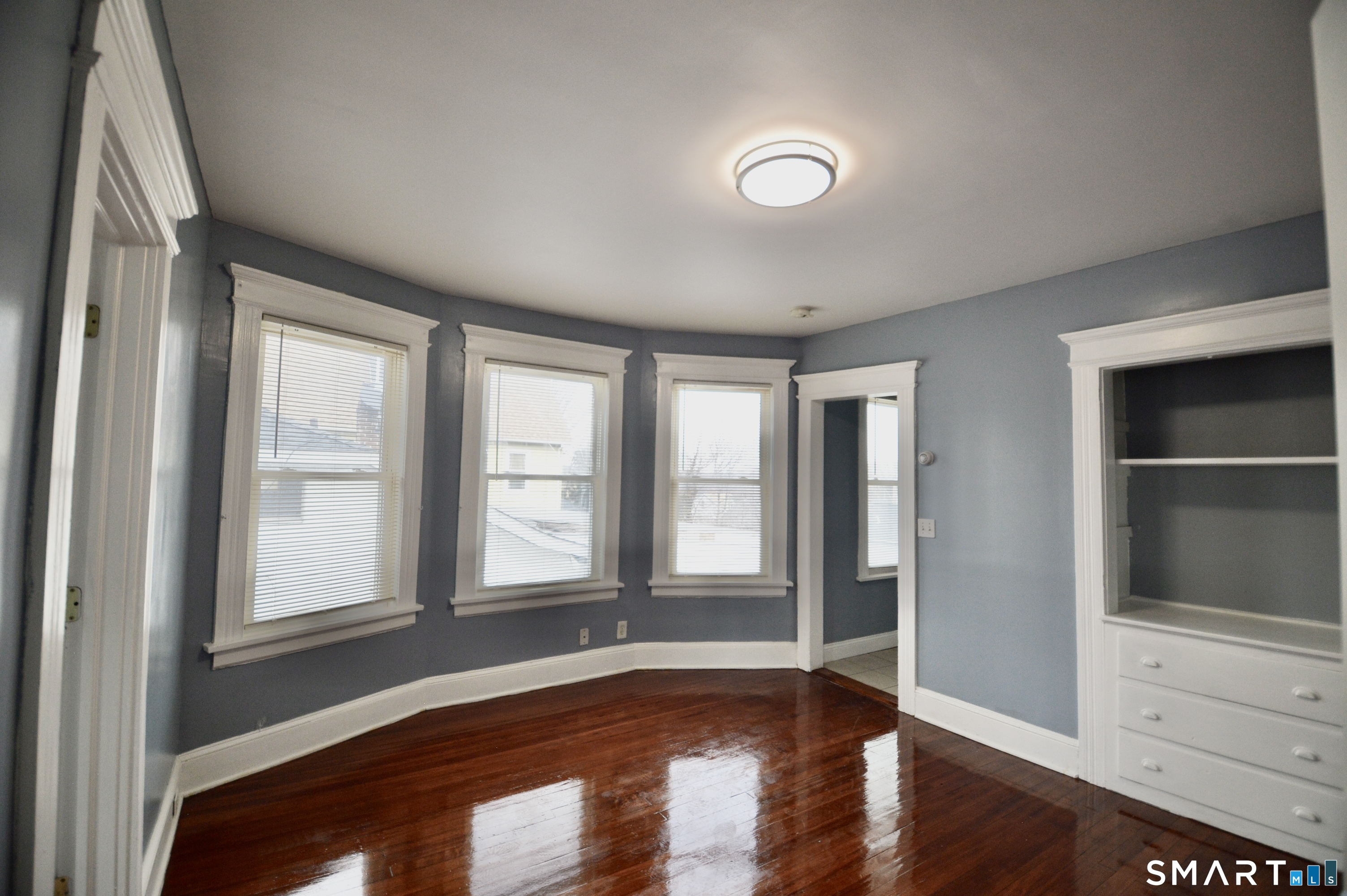 32 Boston Terrace Bridgeport, CT 06610 - Photo 2 of 14 an empty room with wooden floor and windows